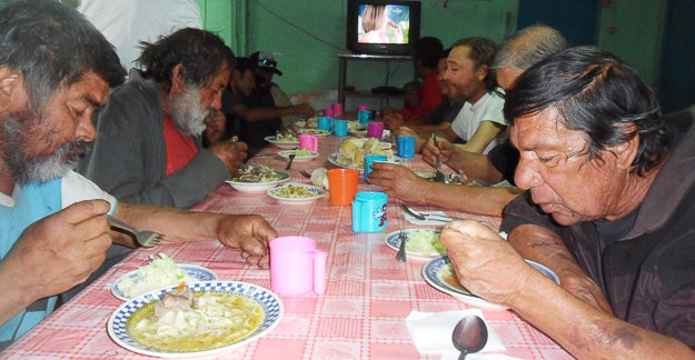 Personas almorzando en el comedor solidario El Águila